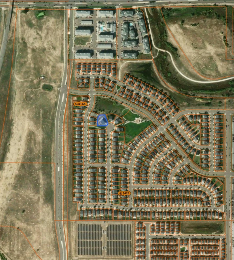 Today's aerial of the same lots: a built-out subdivision of houses, with apartments and a solar array beside it
